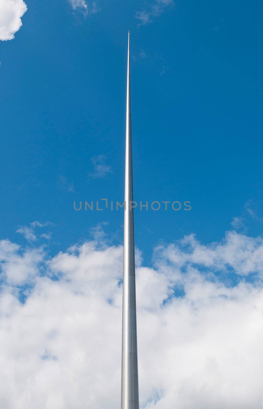 The Spire, officially titled the Monument of Light with 121.2 meters in Dublin, Ireland (gorgeous blue sky with clouds)