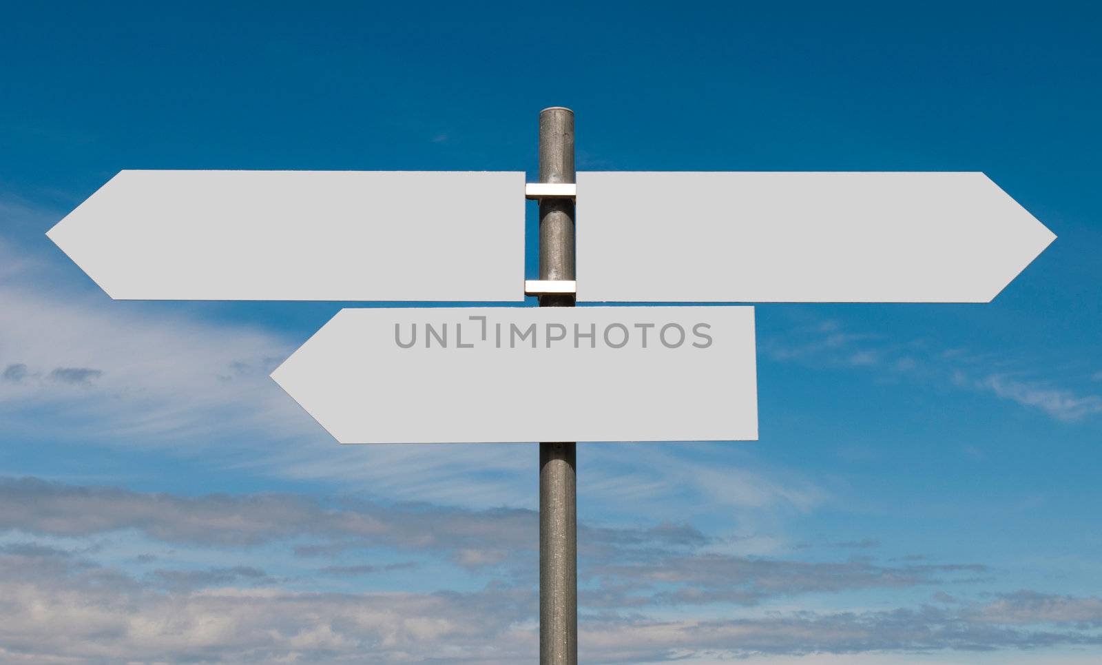 empty multidirectional sign against a blue sky background (boards isolated on grey)