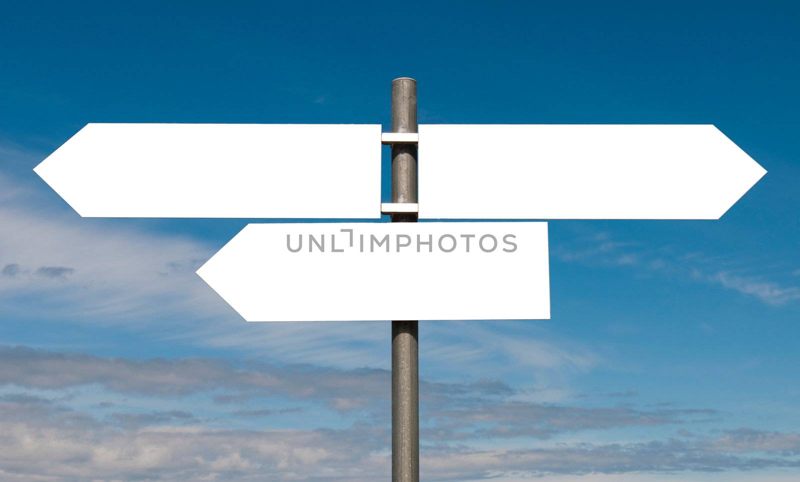empty multidirectional sign against a blue sky background (boards isolated on white)
