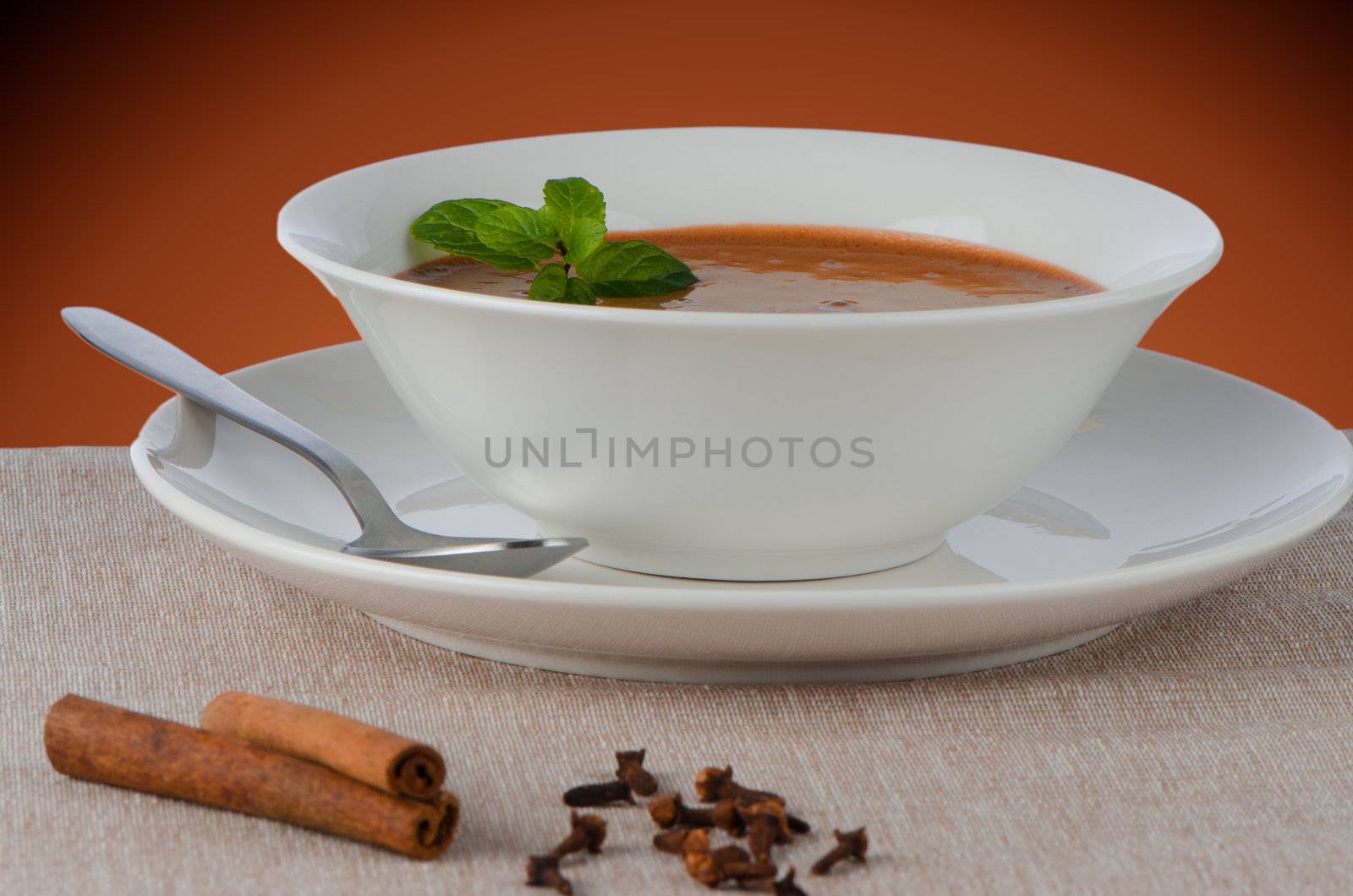 Chocolate mousse ou a white mug with mint leaves.