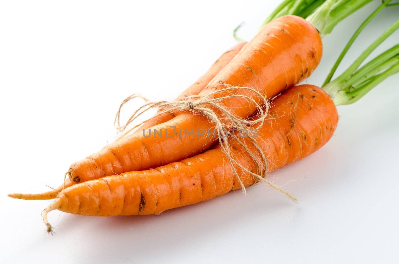 Fresh carrots on white background.