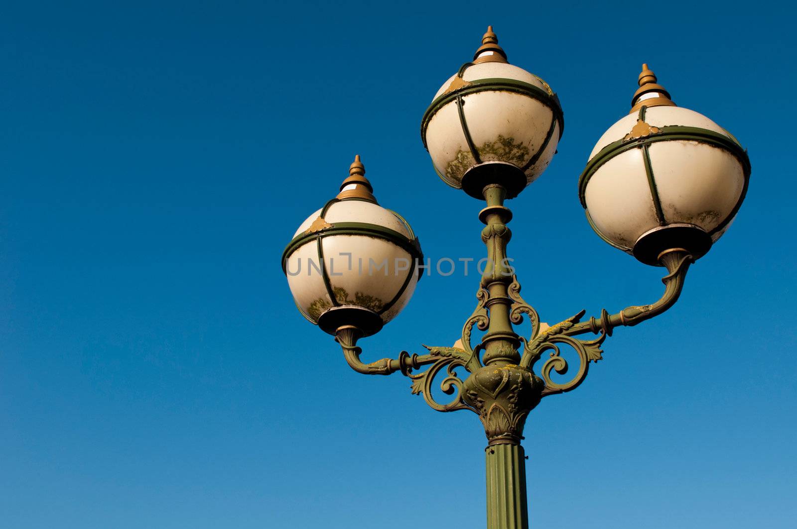 green vintage lamp posts against a blue sky background (Limerick, Ireland)