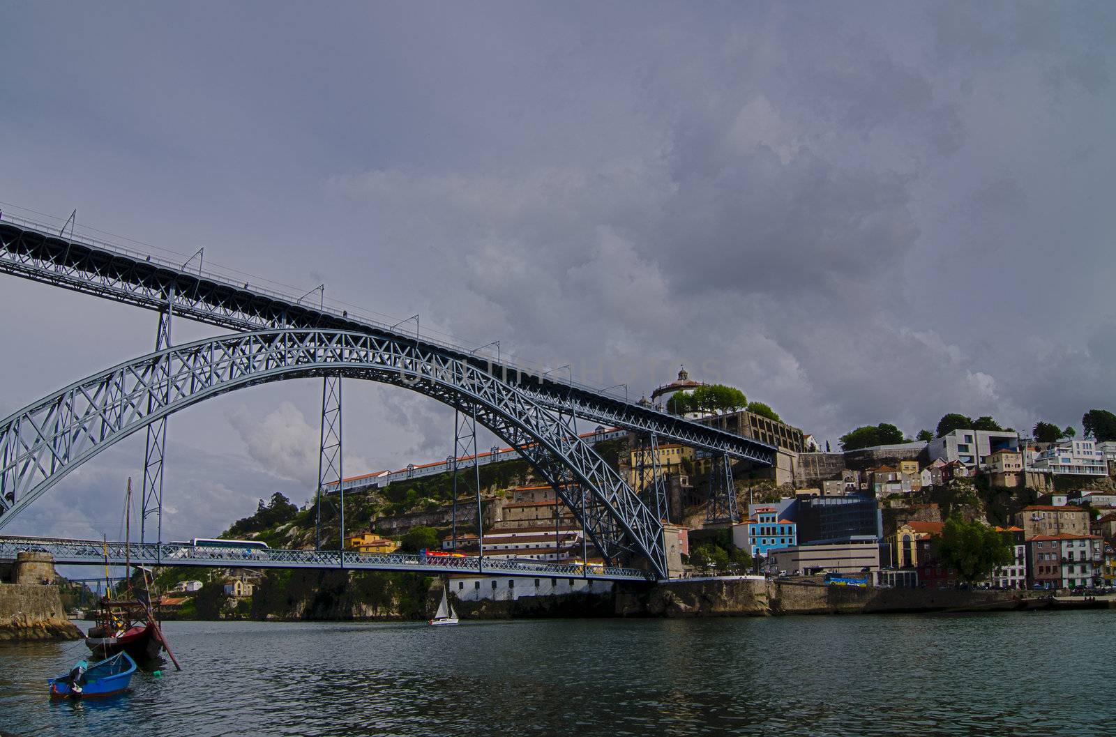 Famous steel bridge Ponte dom Luis above connects Old town Porto with Vila Nova de Gaia at river Duoro, Portugal