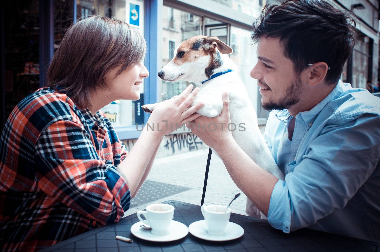 couple at the bar with jack russell in the city