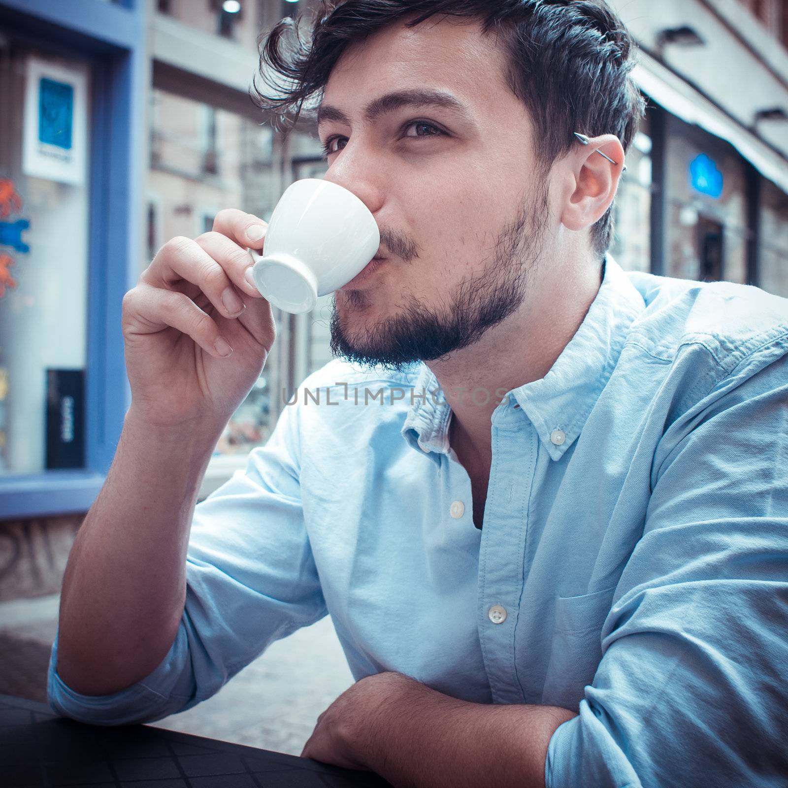 stylish man drinking a coffee at the bar by peus