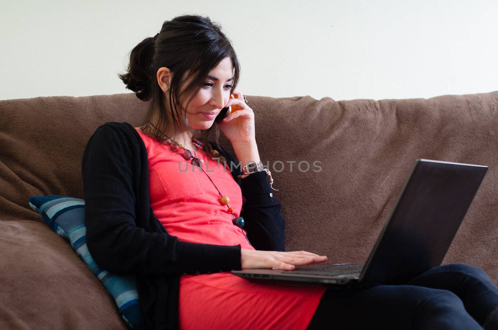 woman at home using notebook on couch