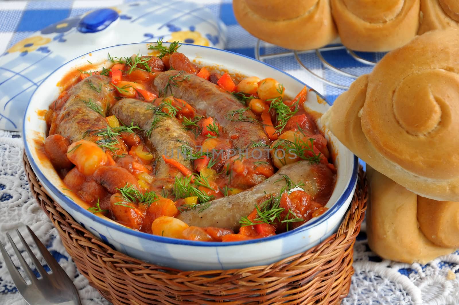 Home sausage with beans, onions and carrots in a tomato sauce