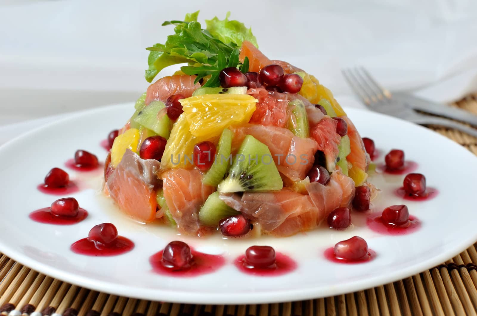 Fruit salad with salmon and pomegranate by Apolonia