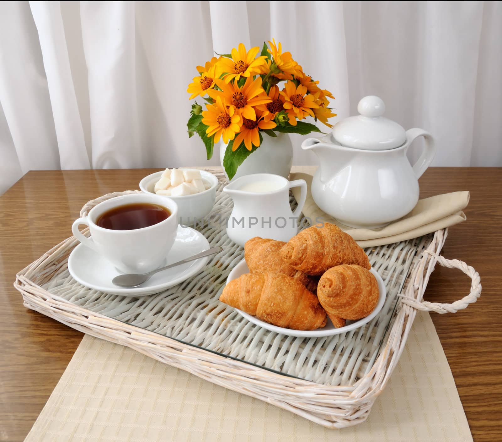 croissants with tea and milk on a tray by Apolonia