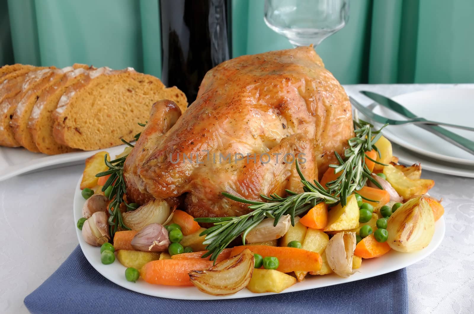 Baked chicken with vegetables and whole rosemary

