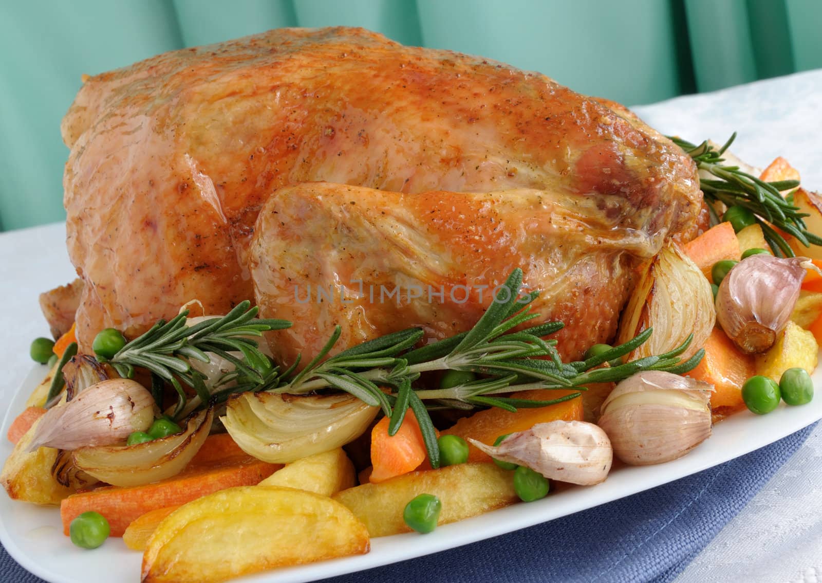 Baked chicken with vegetables and whole rosemary

