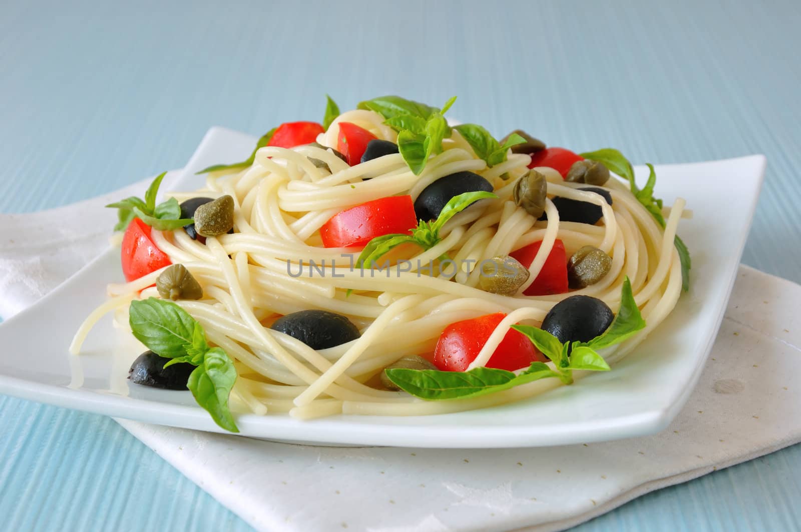Spaghetti with tomato, capers and basil with olives by Apolonia