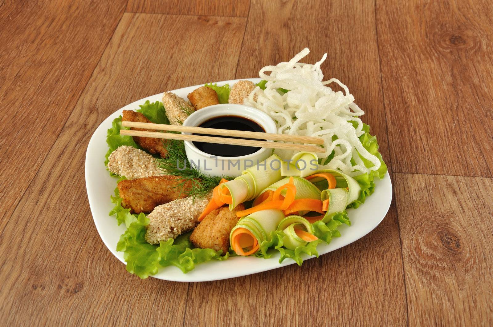 Chicken fillet in breadcrumbs and sesame with fried rice noodles with vegetables