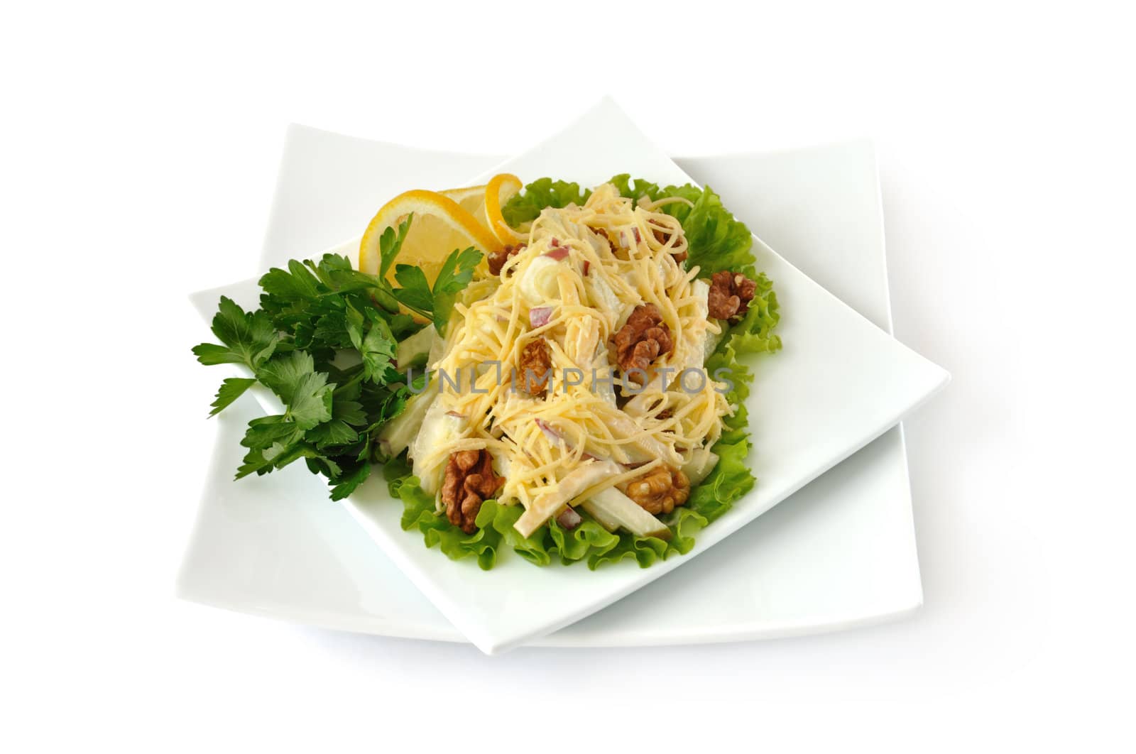 Salad with cheese and apple, walnuts and yogurt on lettuce leaves with lemon isolated