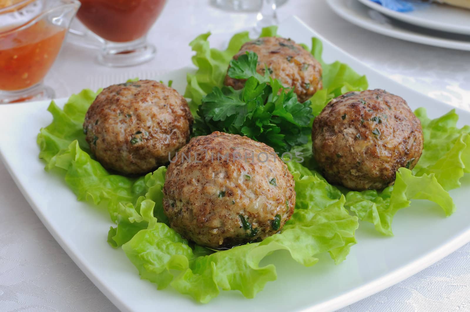  Meatballs with greens on salad leaves closeup