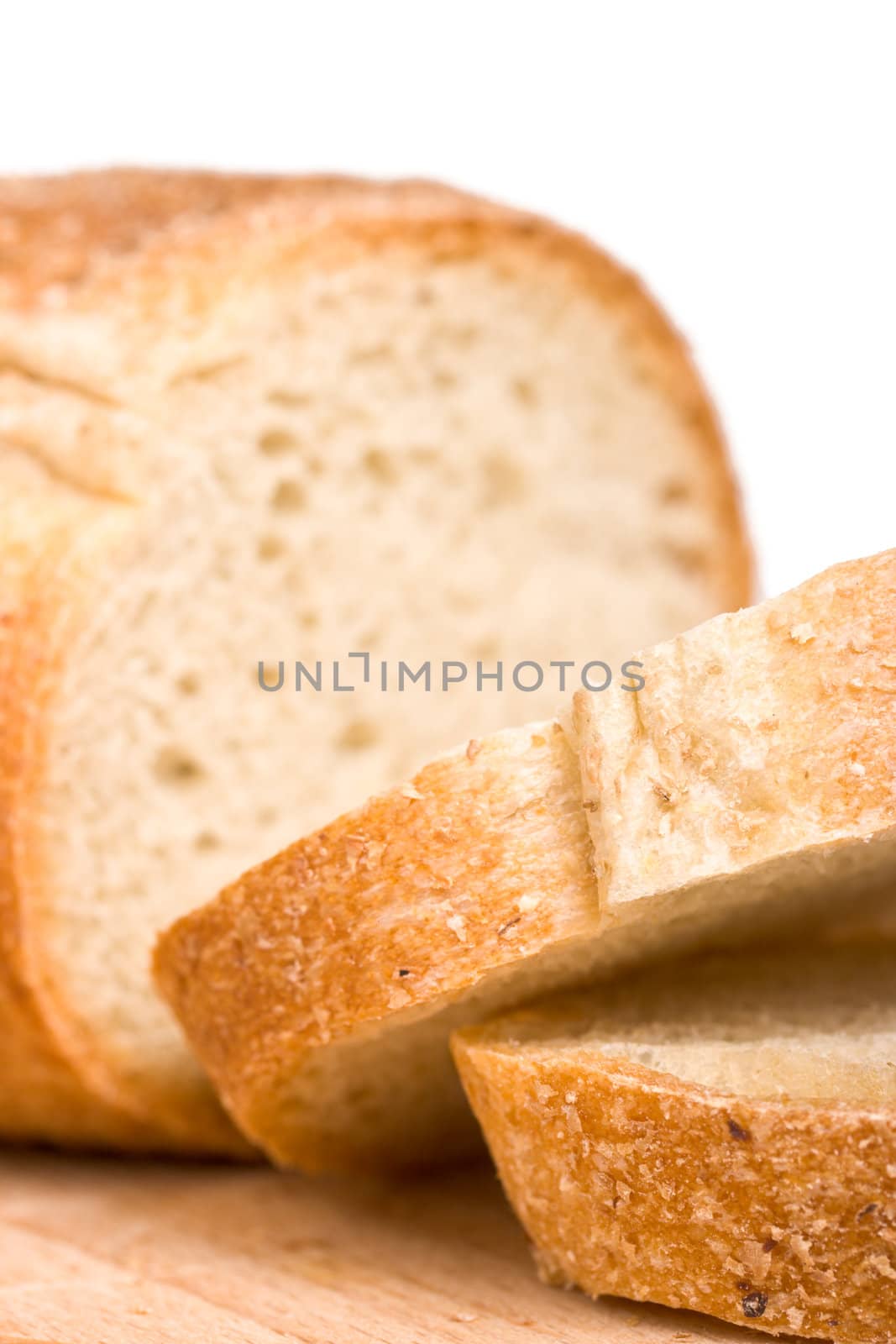 Sliced bread on wooden plate by dimol