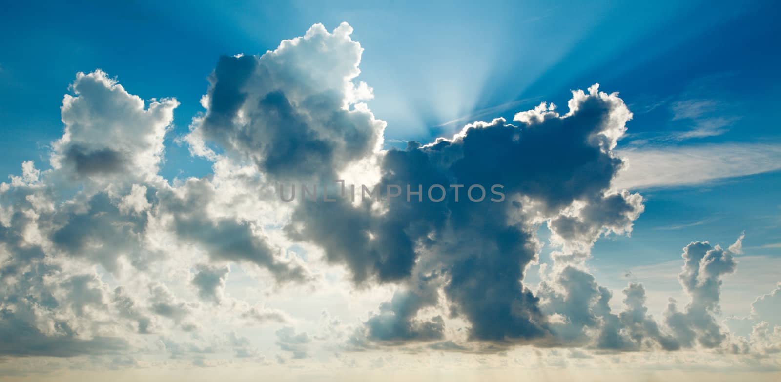 Clouds in sky with sunrays on sunrise