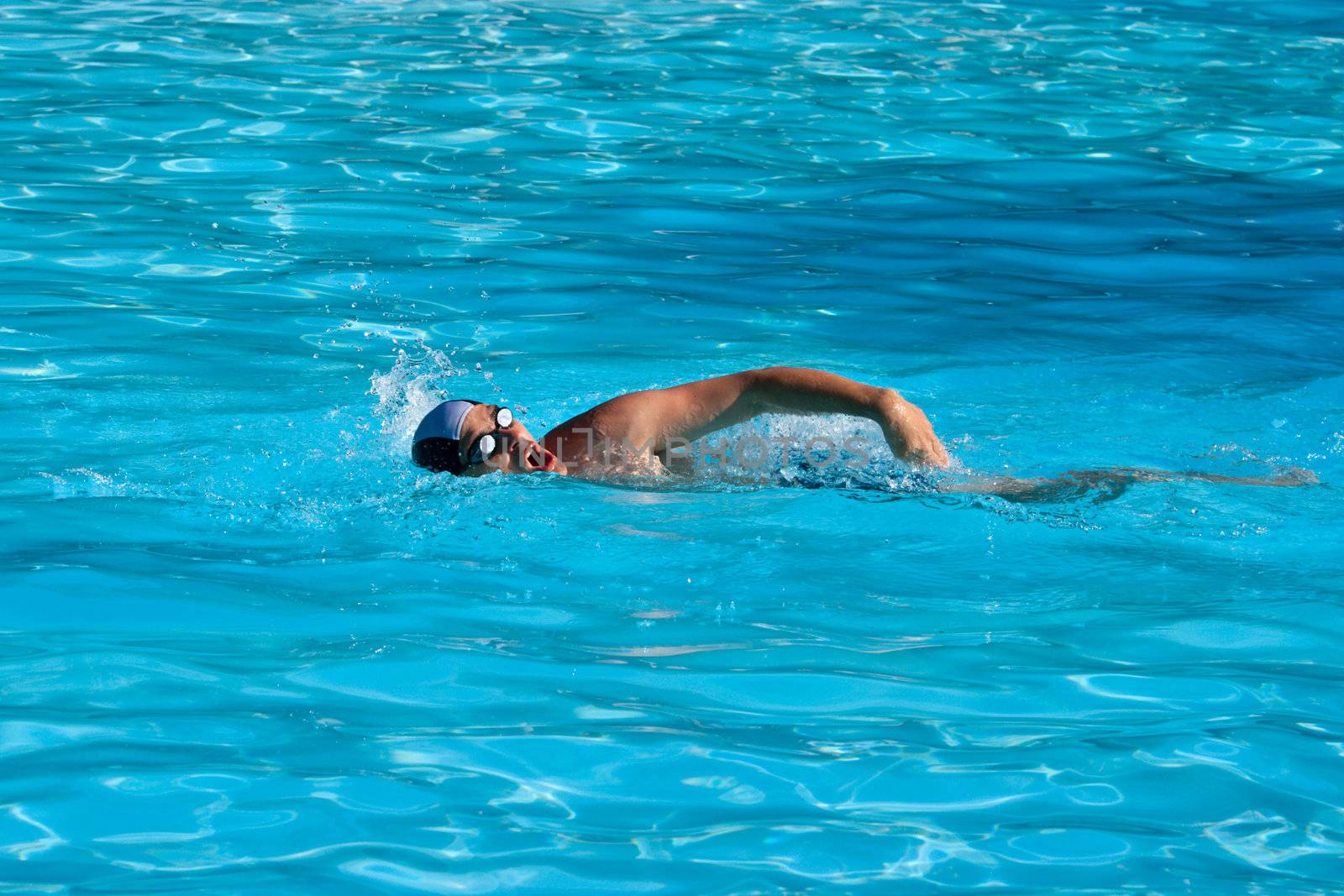 Athletic Man swimming in the pool