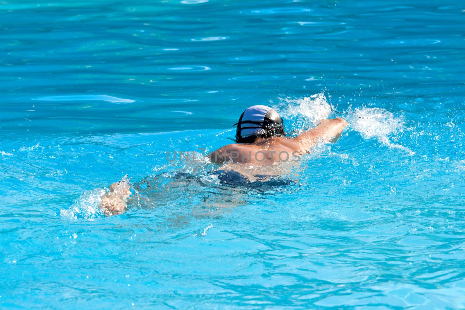 Athletic Man swimming in the pool