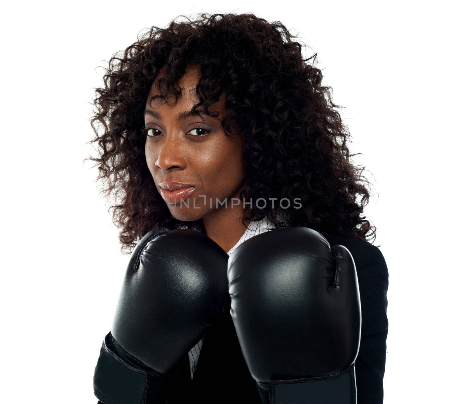 Beautiful female executive wearing boxing gloves. Get ready for some action