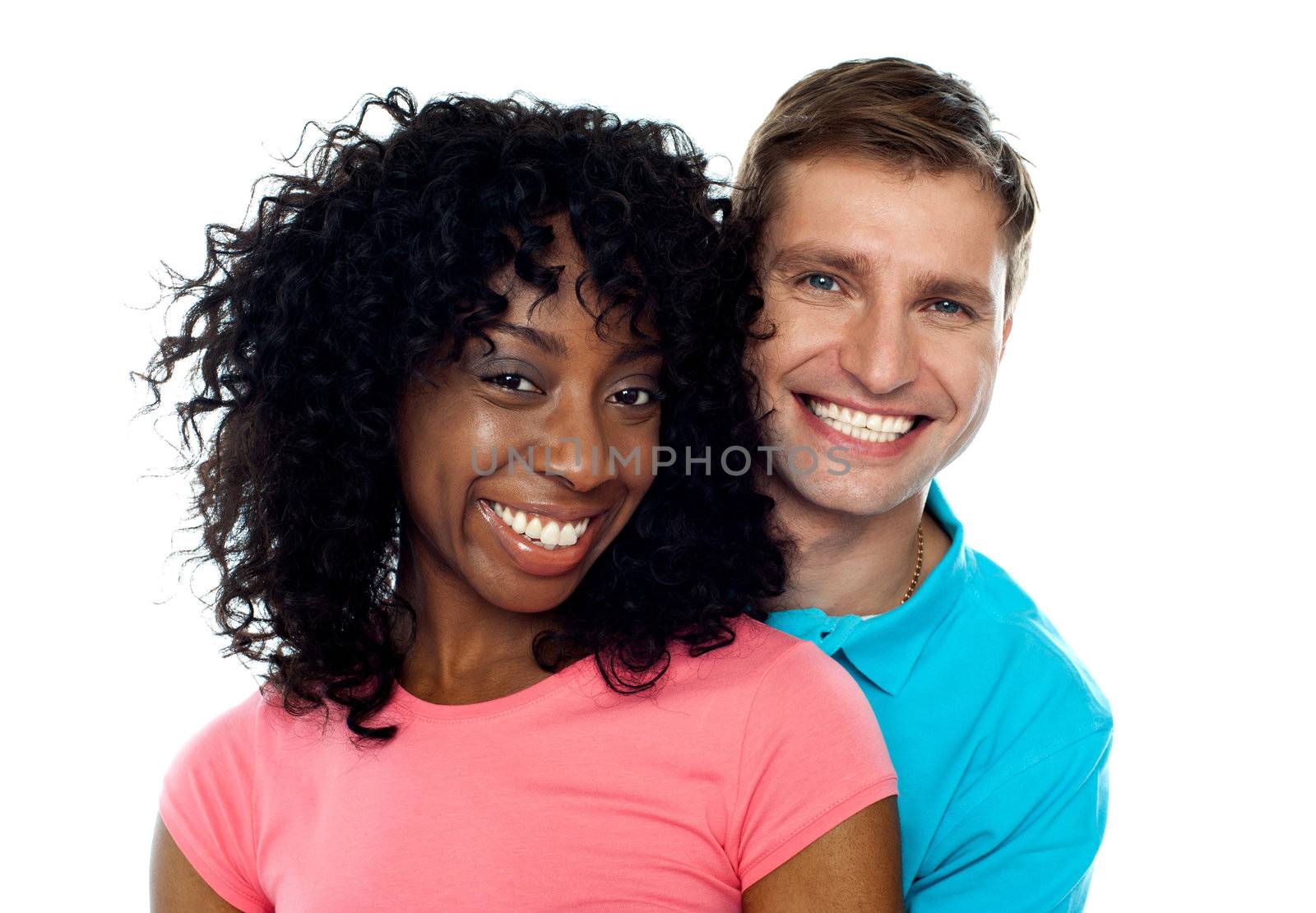 Couple smiling with joy and looking at camera. Hugging in love