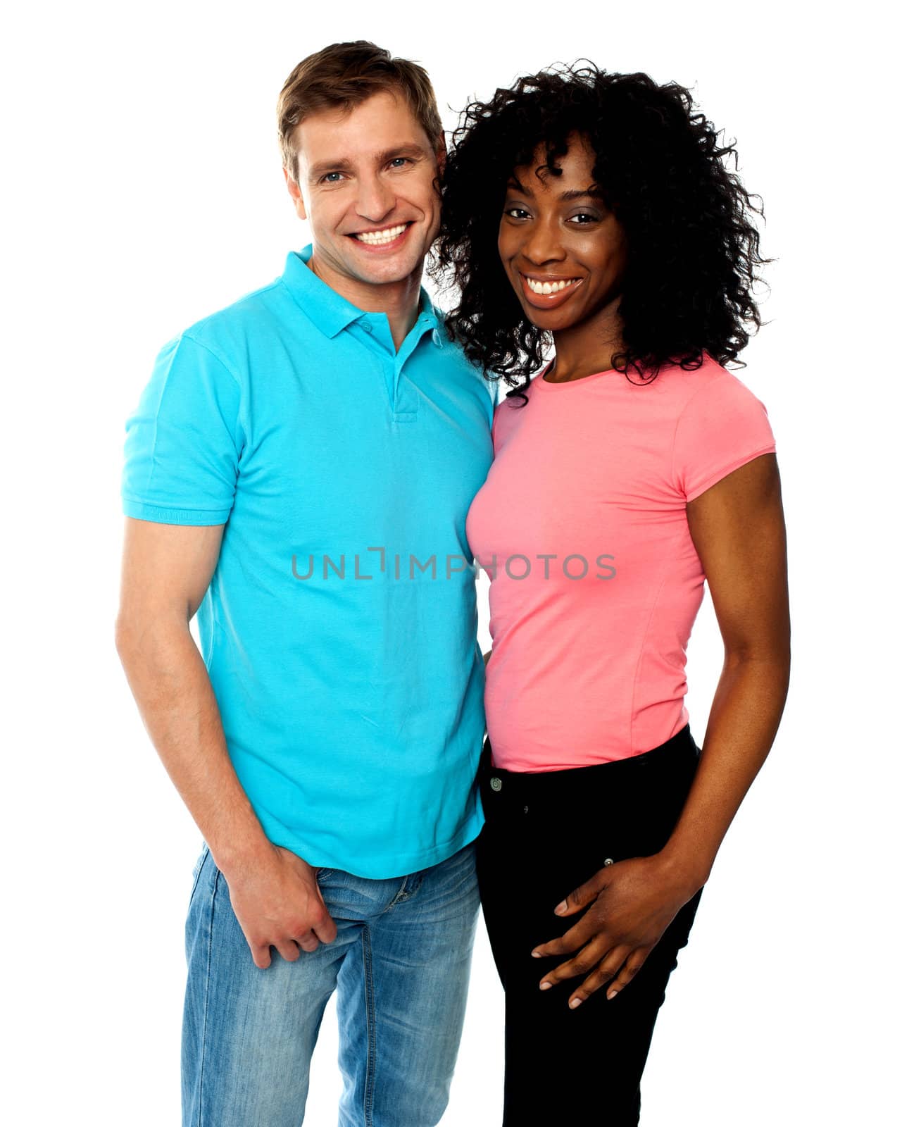 Attractive smiling couple hugging against white background