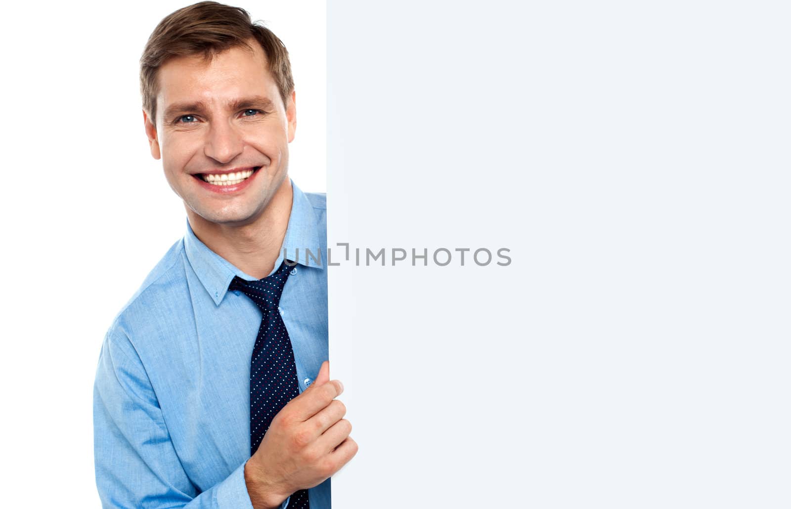 Business man holding a long blank banner ad by stockyimages