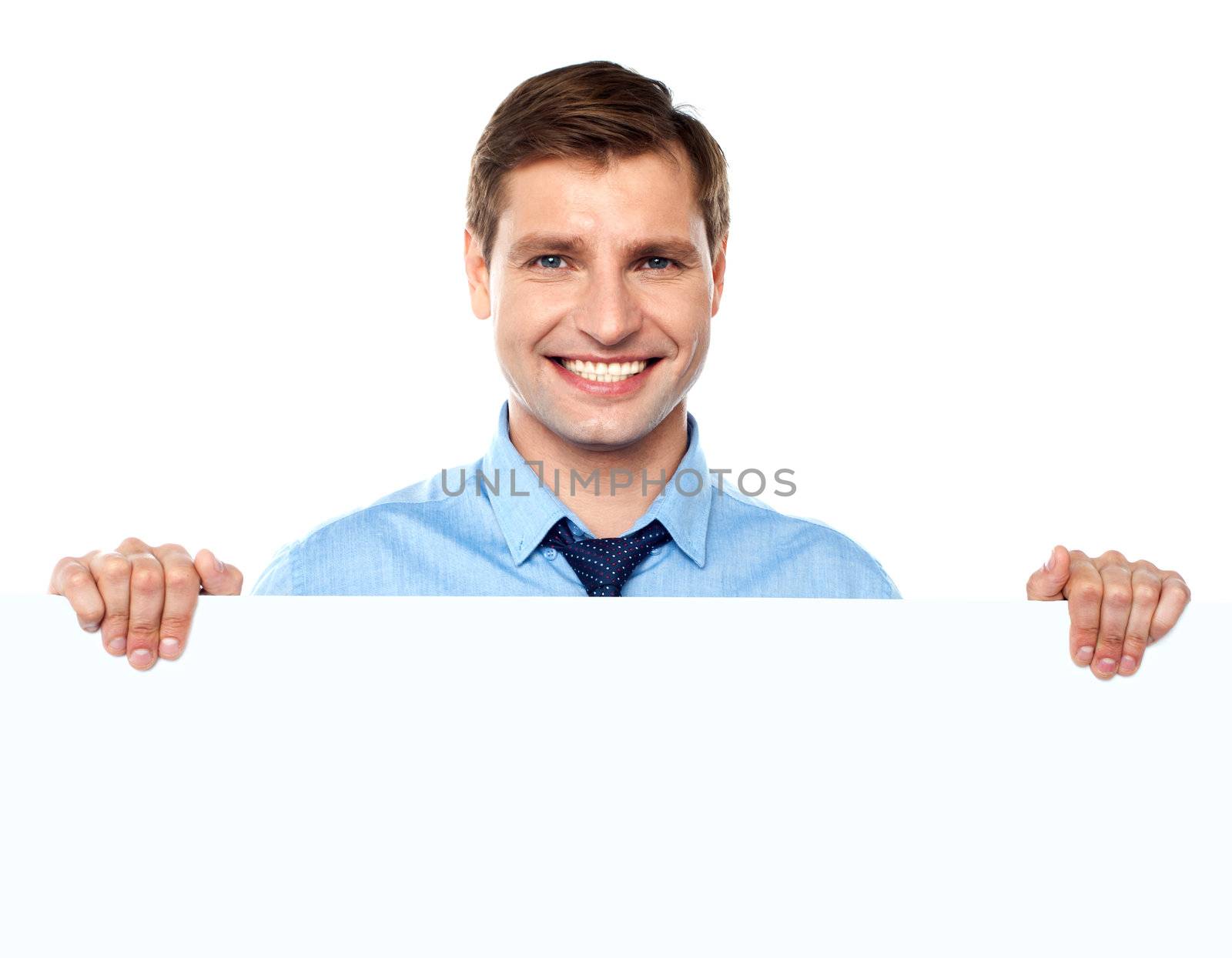 Smiling entrepreneur promoting big blank banner ad isolated on white