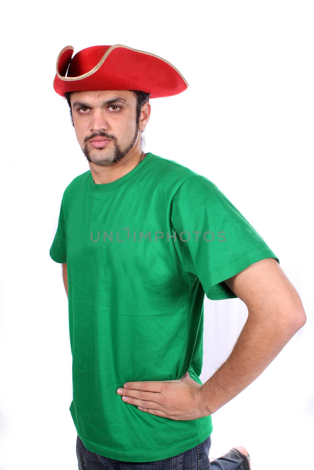 A young Indian guy wearing a red ship captain hat, on white studio background.
