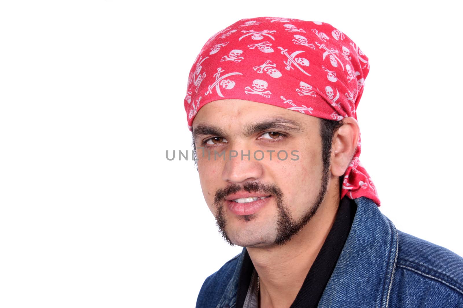 A portrait of a stylish handsome Indian guy wearing a pirates headgear, on white studio background.