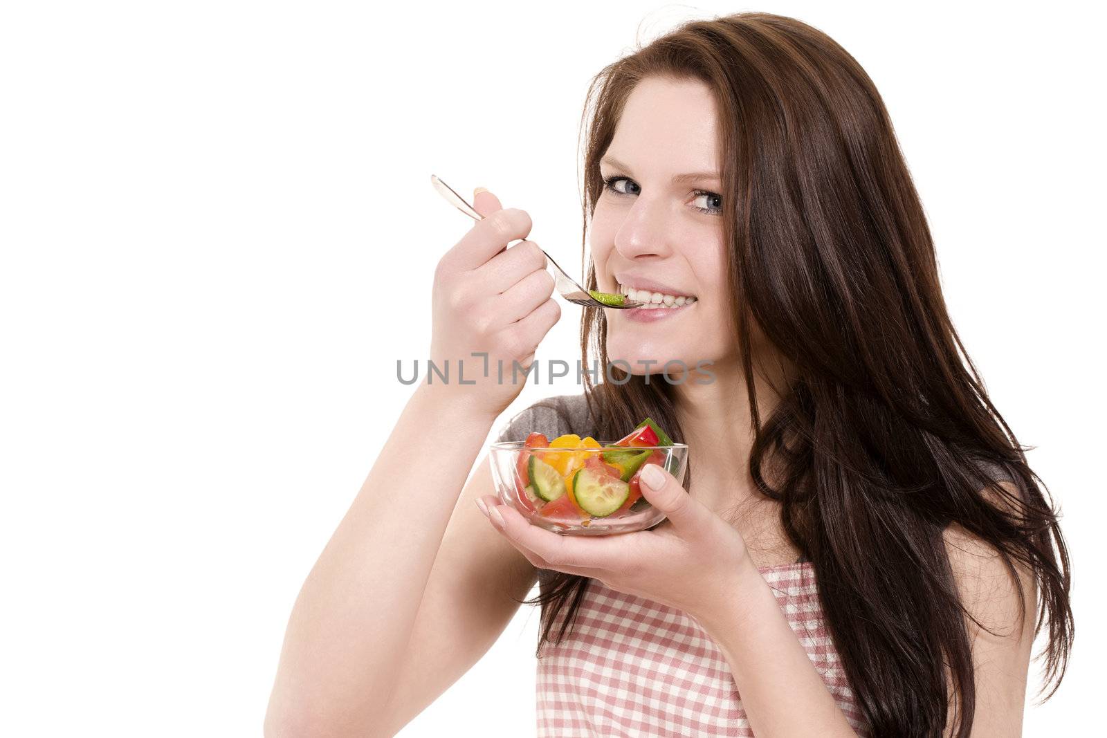 young happy woman eating paprika salad on white background