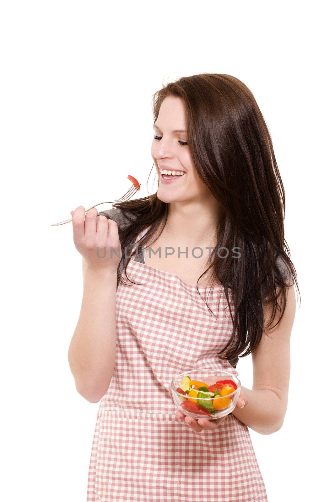 happy young woman with red apron eating salad on white background