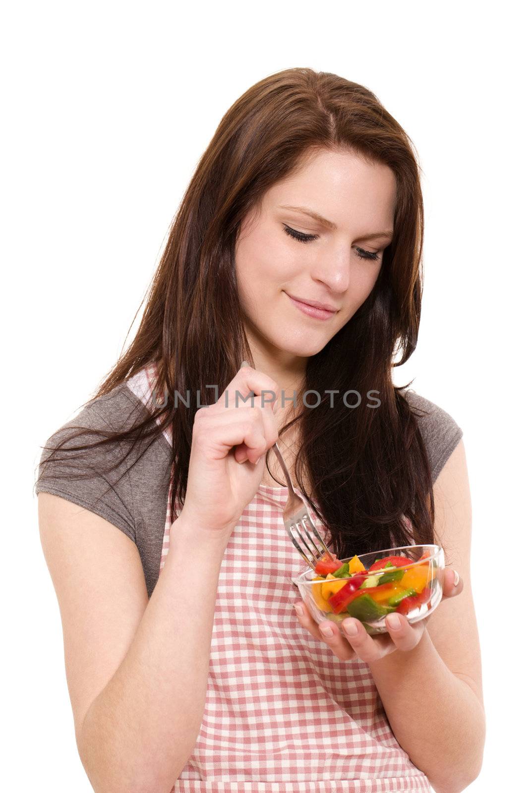 smiling beautiful woman eating mixed salad on white background