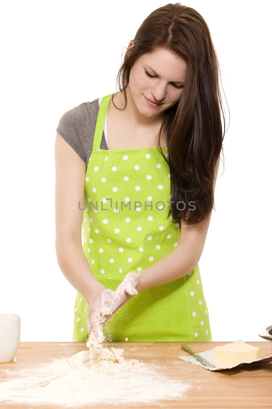 young baking woman cleaning her hands from dough and flour on white background