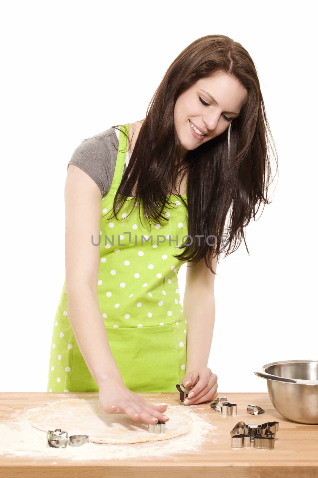 young baking woman using christmas molds on dough with white background