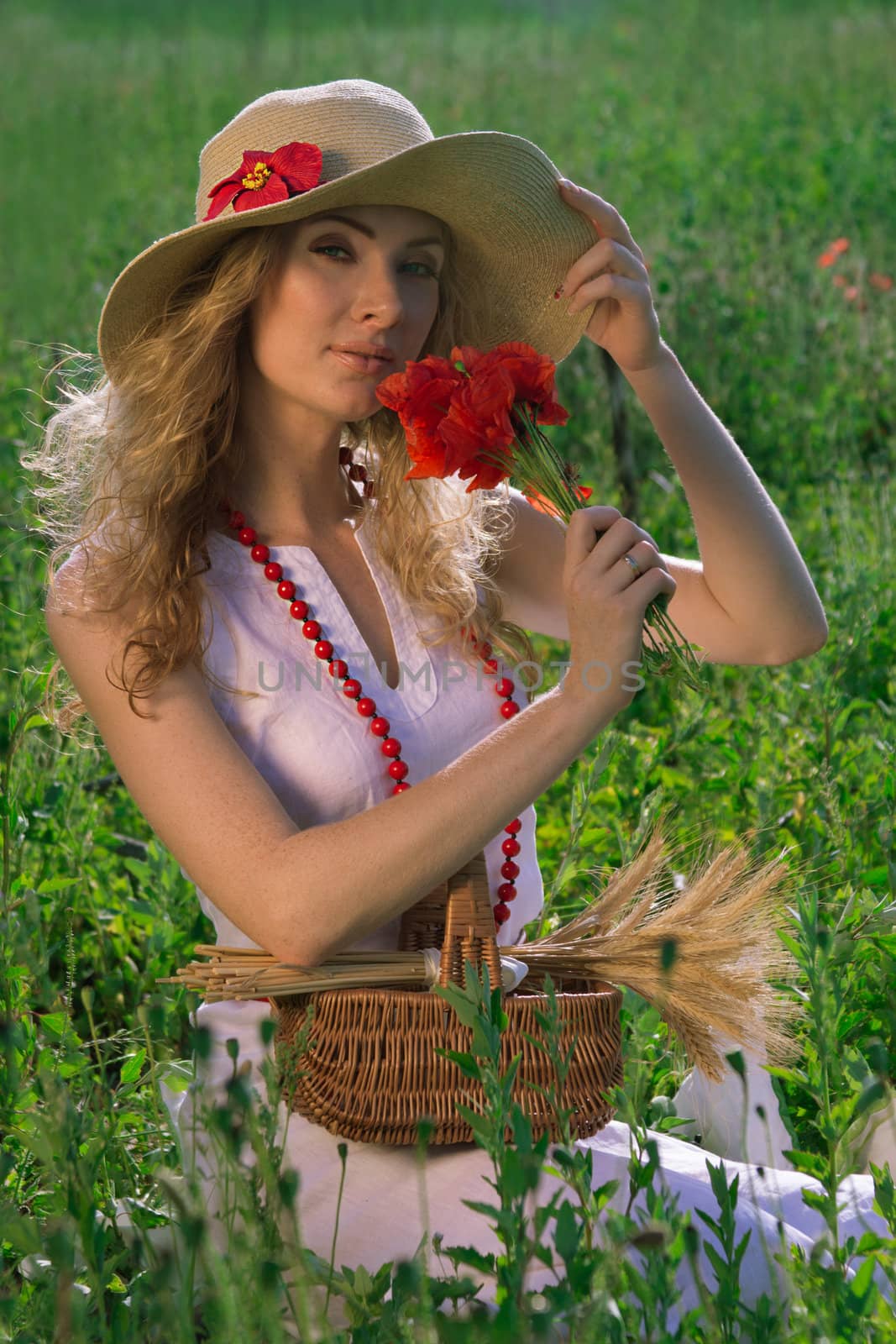 Woman in hat with poppy bouquet in midow