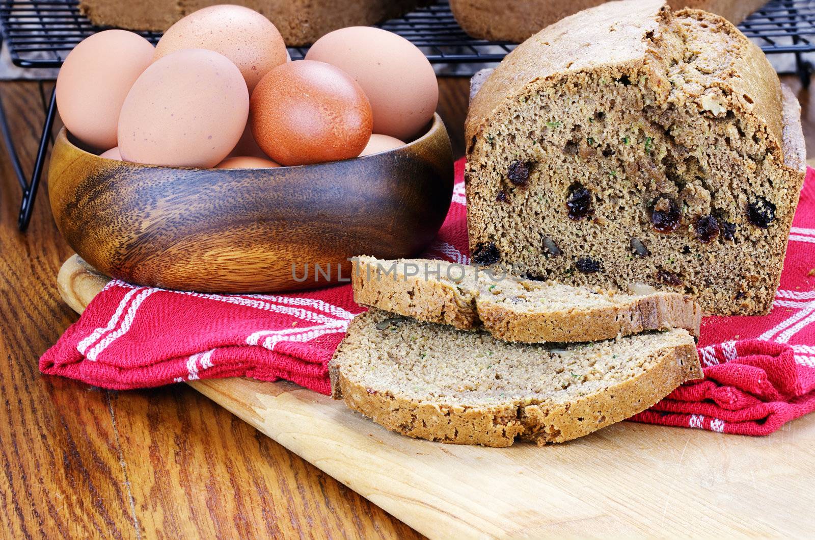 Freshly made and sliced zucchini bread with fresh eggs. 
