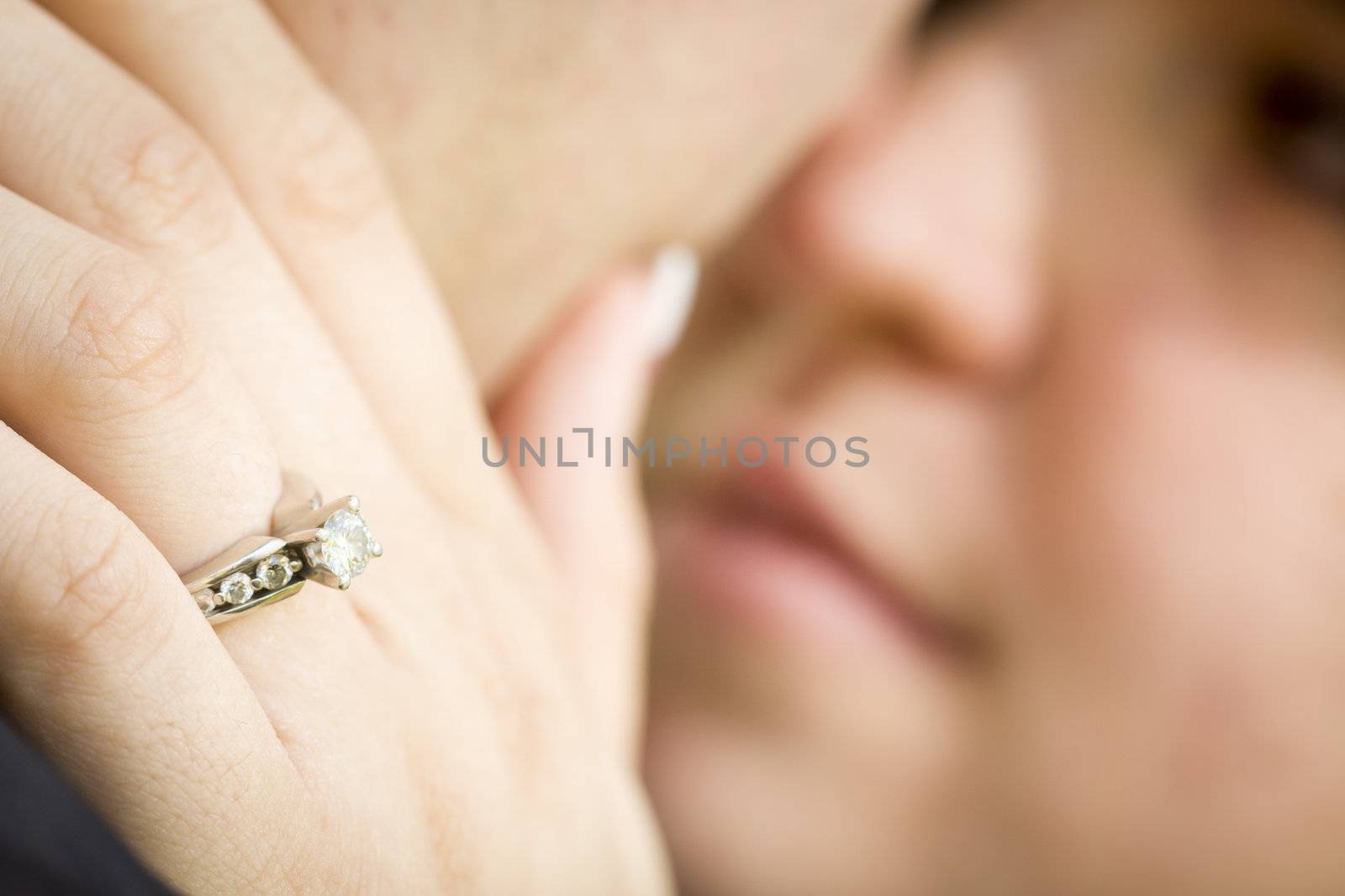 Female Hand with Engagement Ring Touching Fiance's Face by Feverpitched