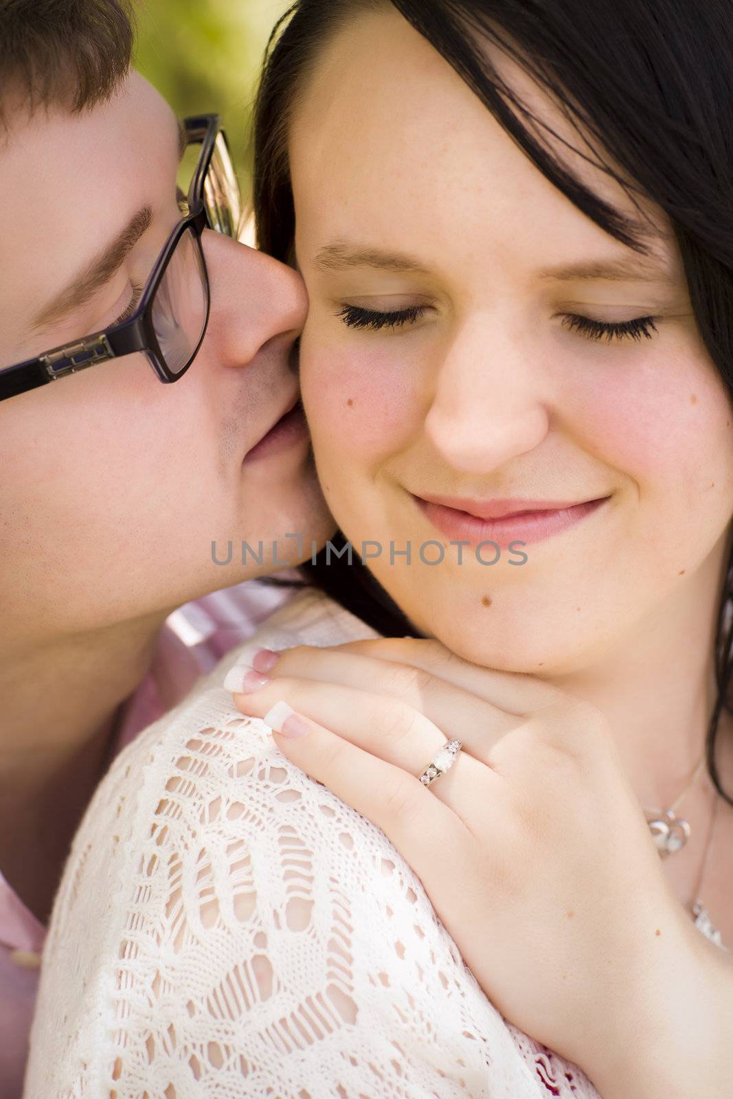 Attractive Young Engaged Couple Sharing an Intimate Moment in the Park.