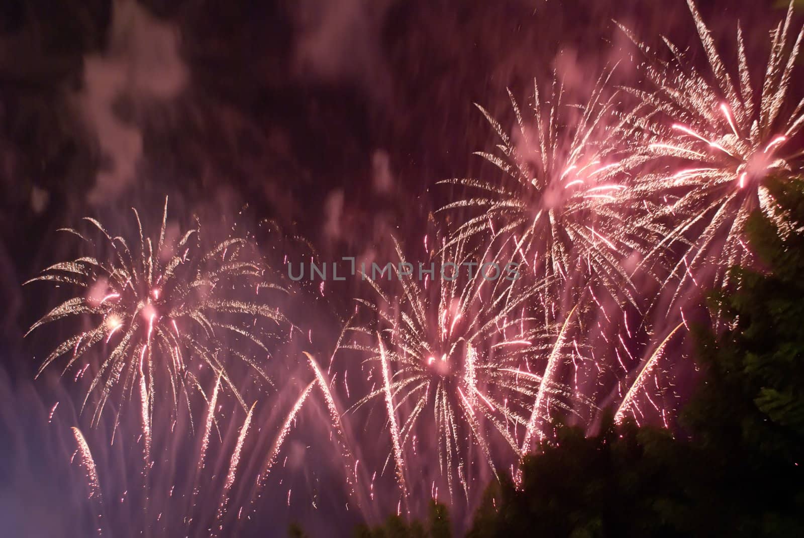 Colorful fireworks over dark sky, displayed during a celebration of Santa