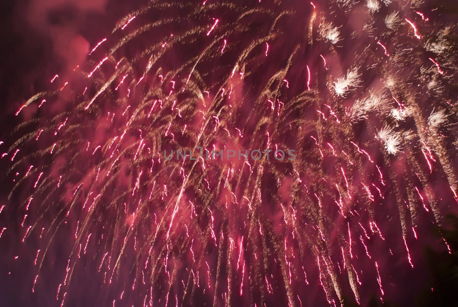 Colorful fireworks over dark sky, displayed during a celebration of Santa