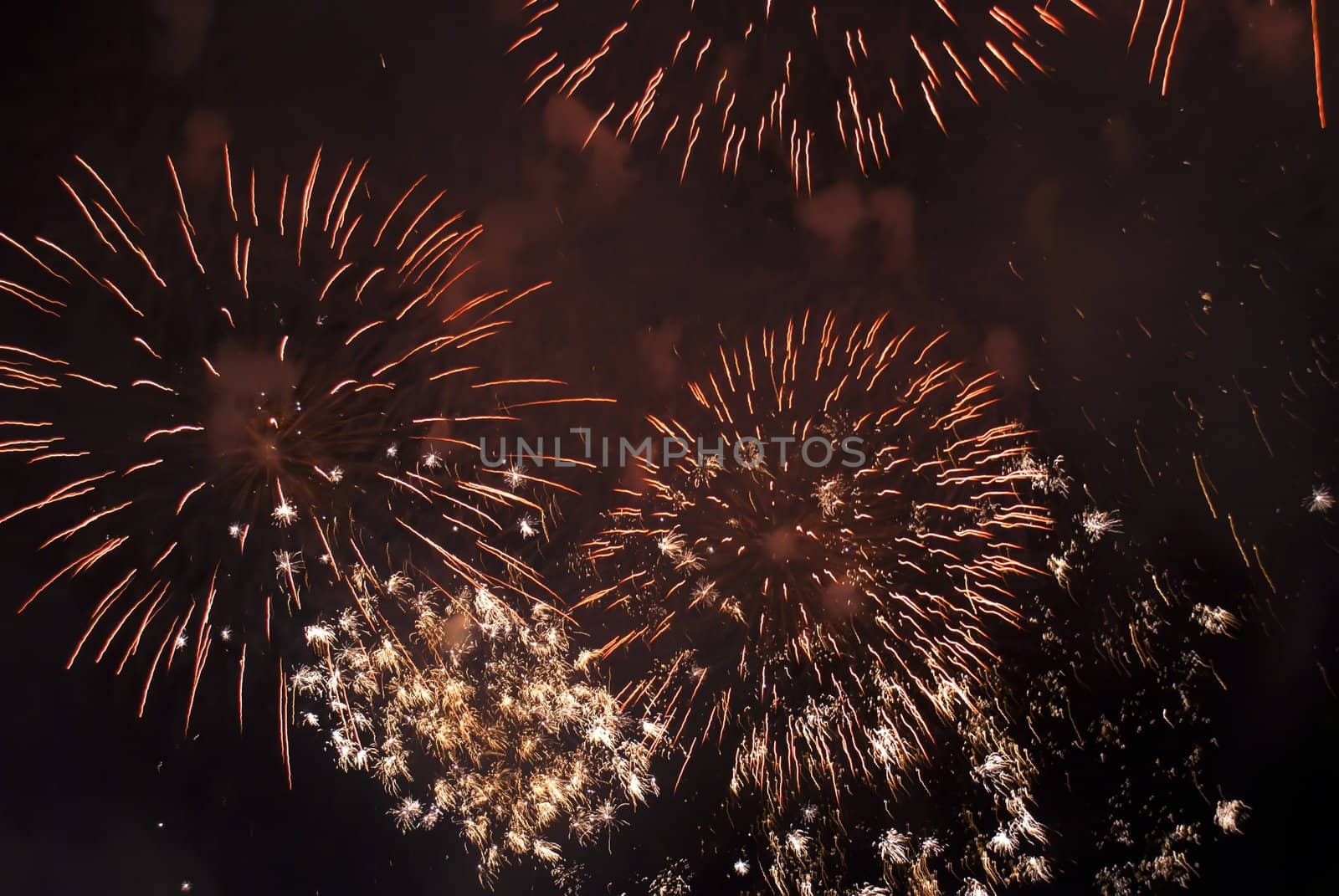 Colorful fireworks over dark sky, displayed during a celebration of Santa