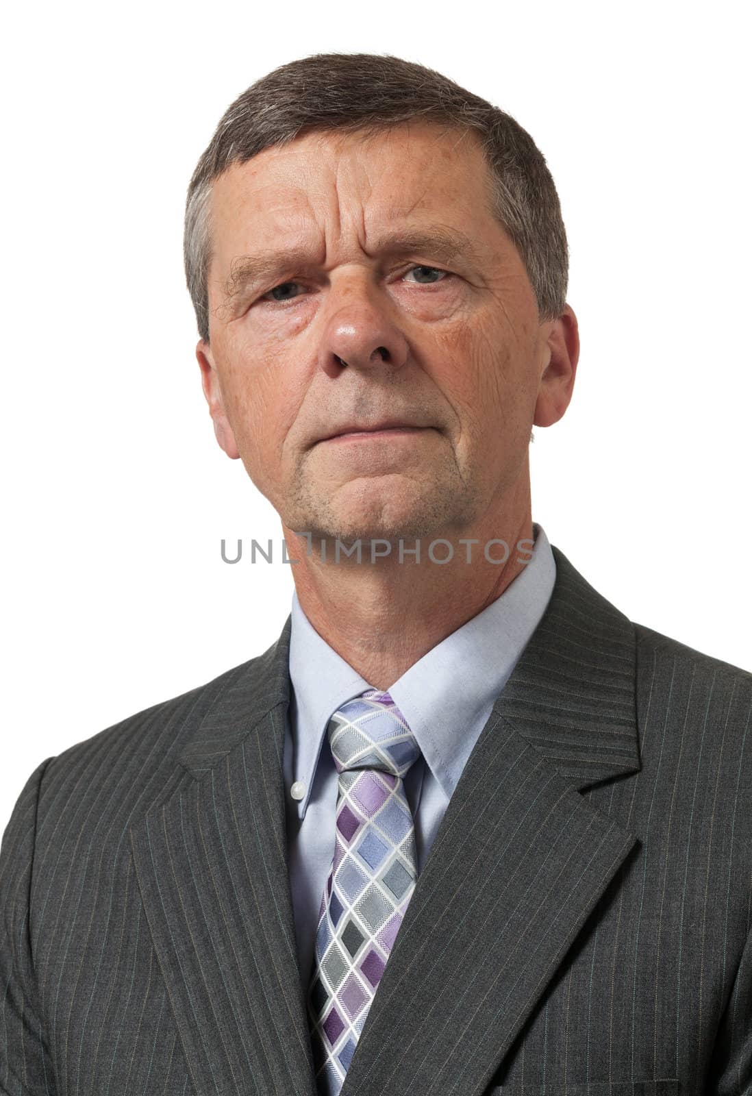 Retired executive looks pensively towards the camera and isolated against white