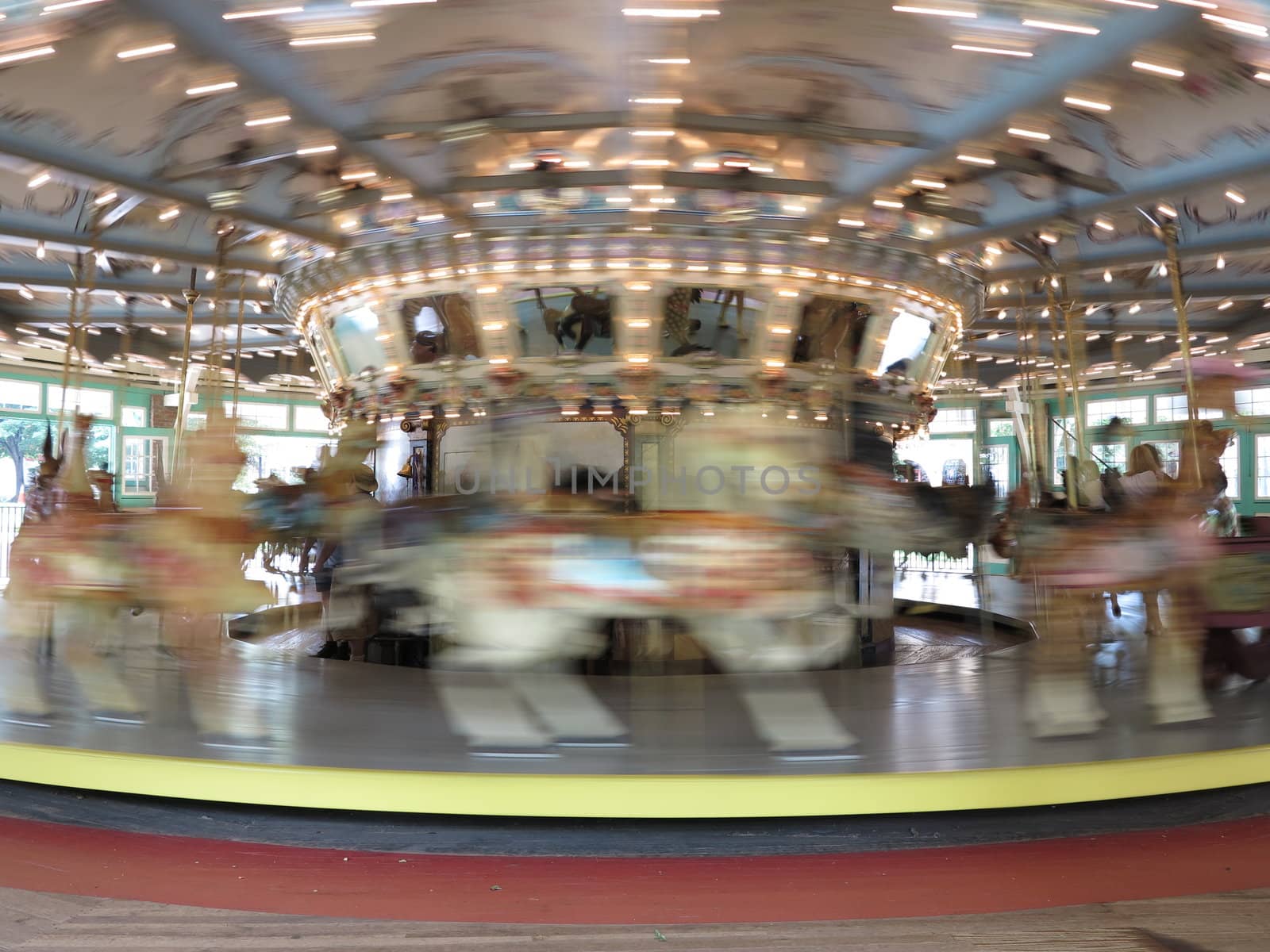 Antique carousel with carved horses at Glen Echo National Park in Maryland with motion blur