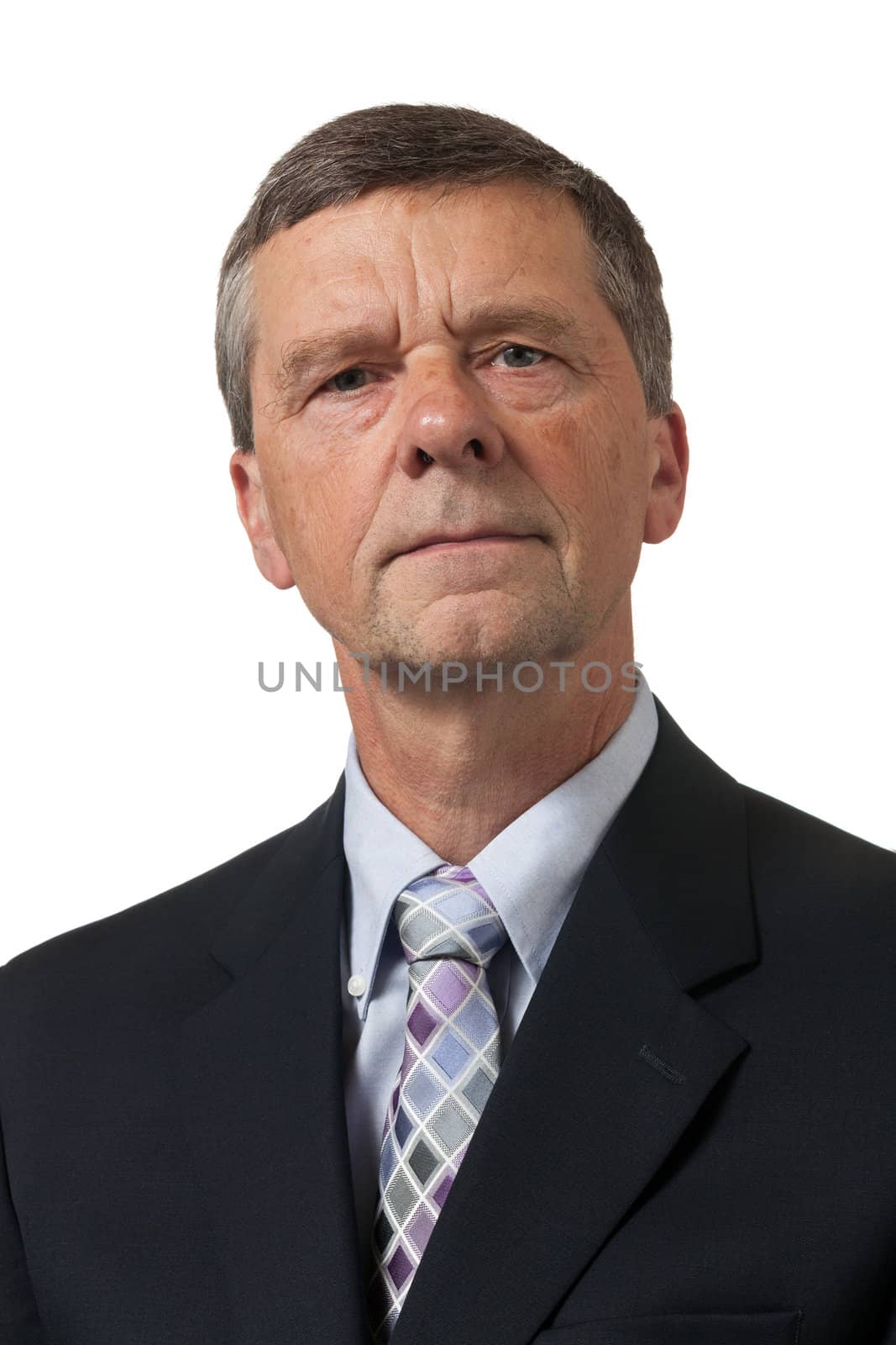 Retired executive looks pensively towards the camera and isolated against white