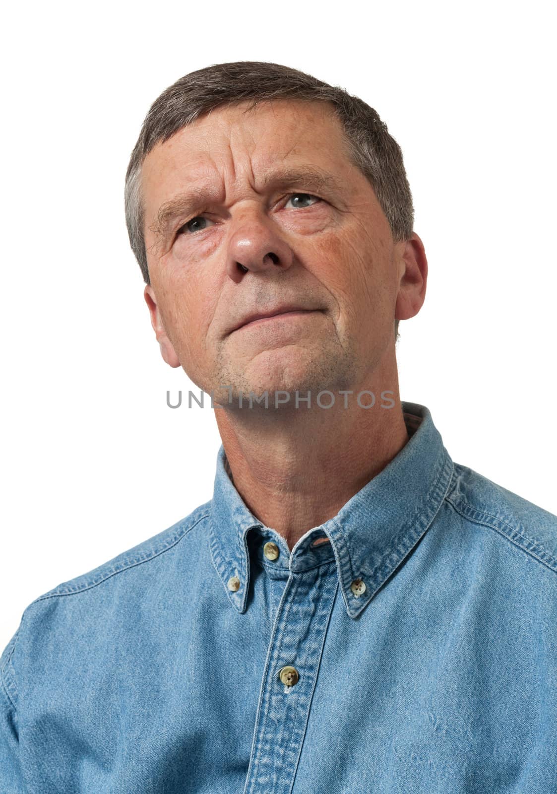 Senior man in blue shirt looks pensive by steheap