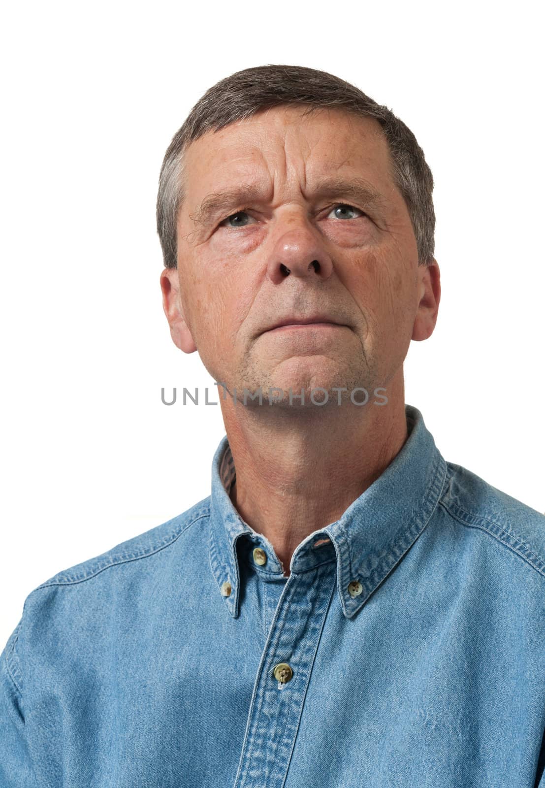 Retired executive looks pensively towards the camera and isolated against white