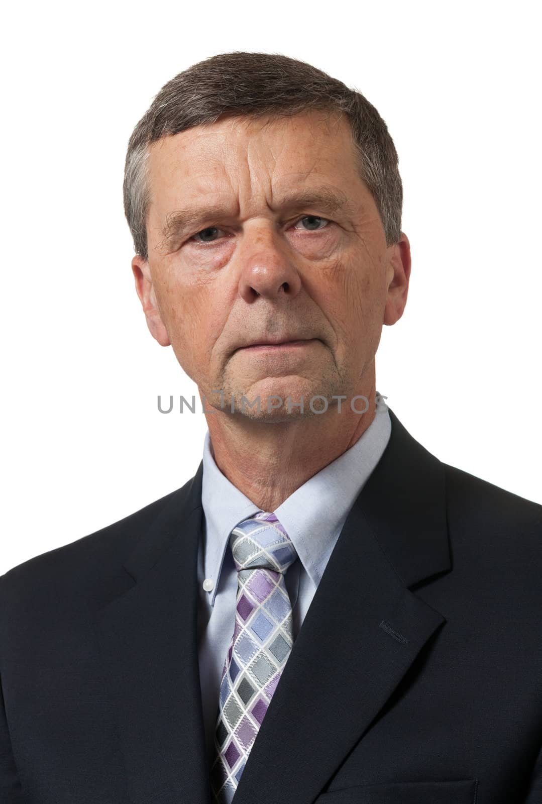 Retired executive looks pensively towards the camera and isolated against white