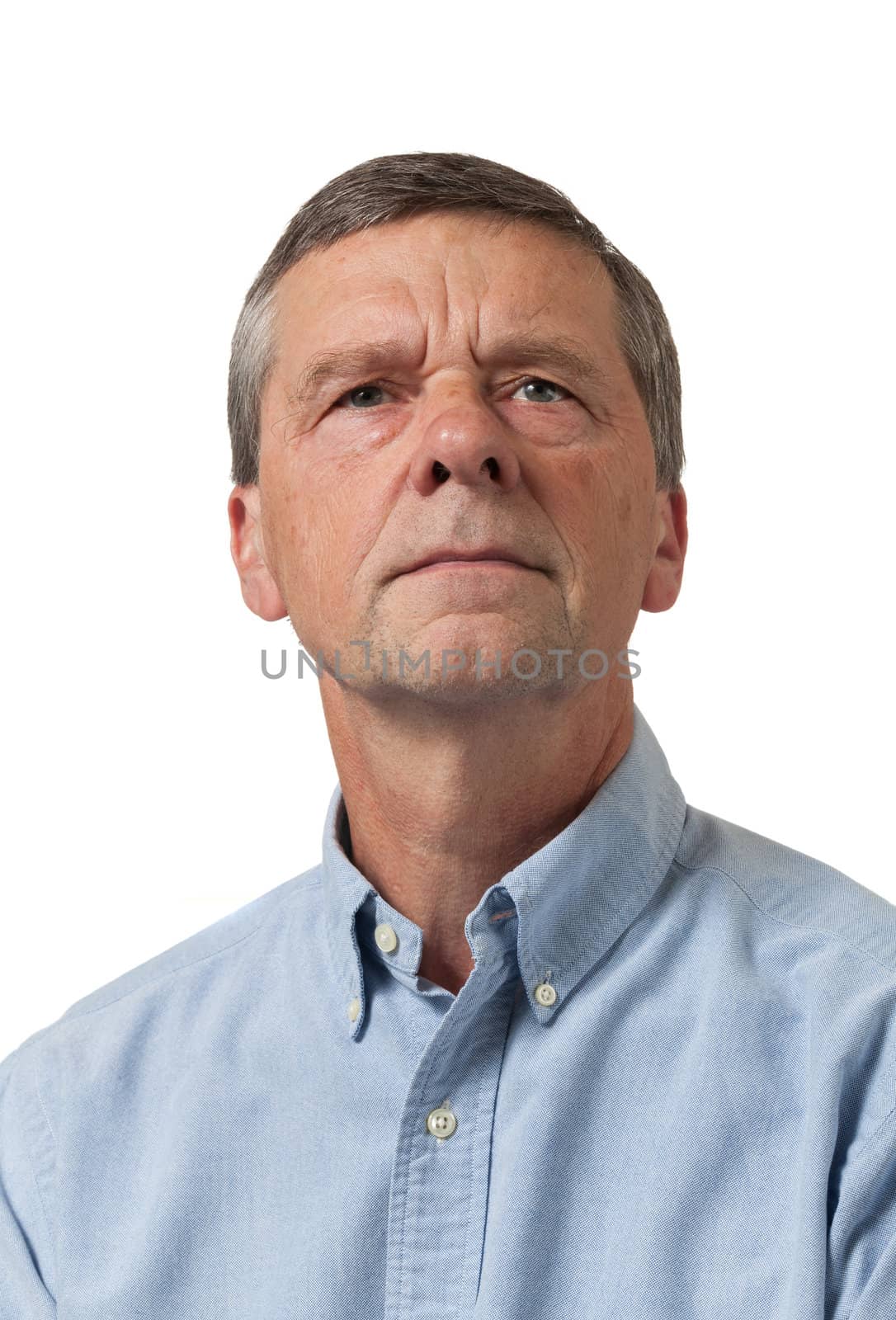 Senior man in blue shirt looks pensive by steheap