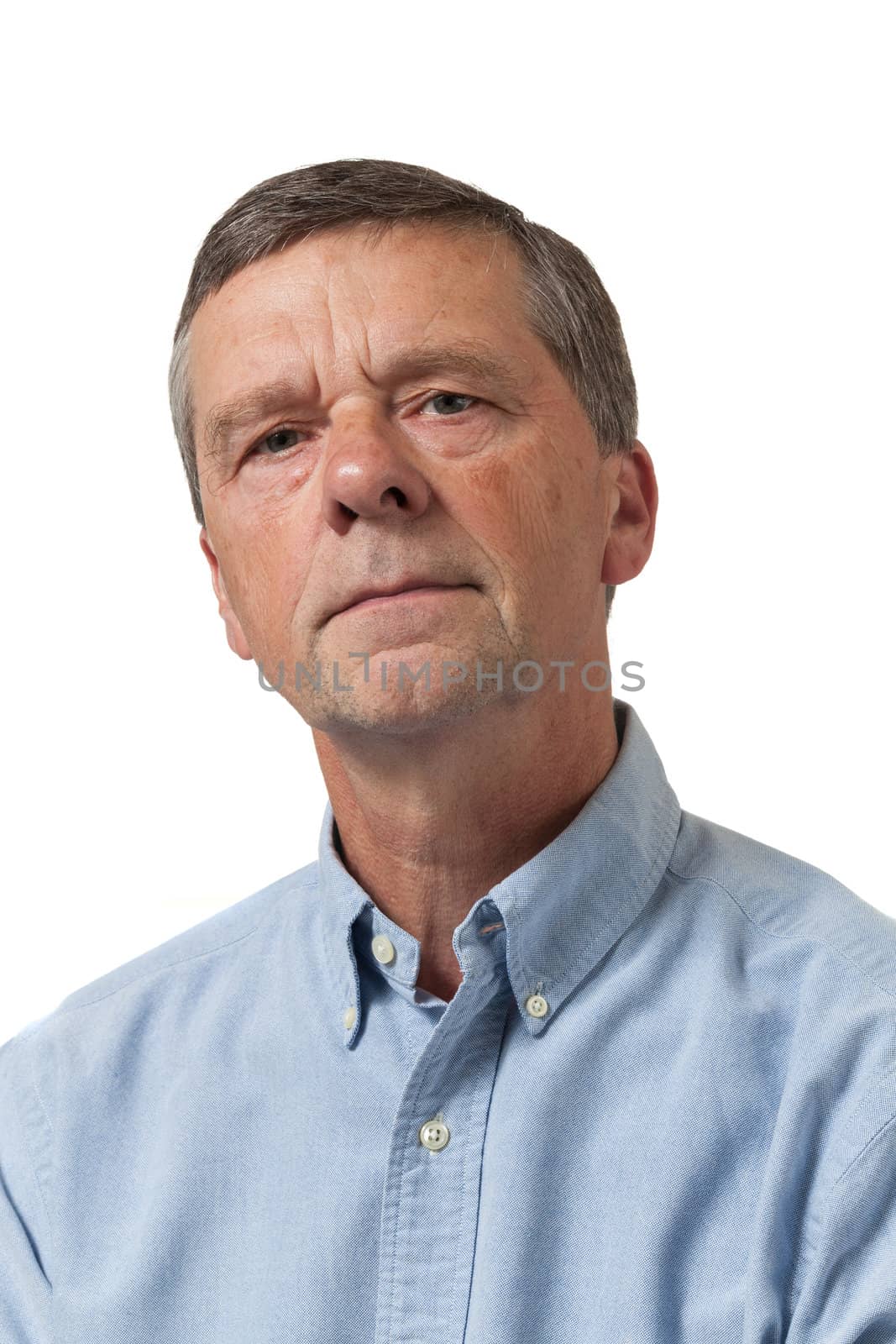 Senior man in blue shirt looks pensive by steheap